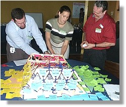 Representatives from Townsville and Thuringowa Councils building the Sustainability Pyramid.