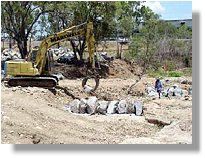 Excavator placing downstream rock cascade fishway (08/12/05)