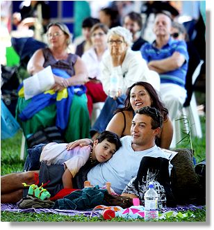 Crowd relaxing in Queens Gardens.