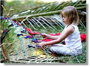 Weaving palm fronds.