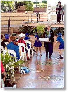 Deputy Mayor Ann Bunnel giving native plants to schools