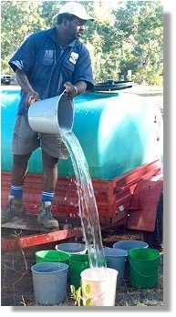 TCC natural area leading hand Eric Maki supplies water during a community planting at Oak Valley.