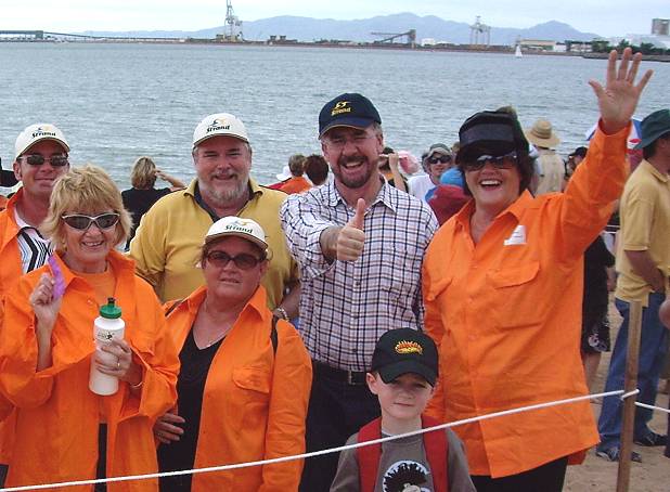 Previous Townsville Mayor Tony Mooney joins the public to spell out Solar City on the Strand beach.